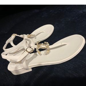 Beautiful Classy Chanel white thong flat sandals, Gold CC logo.  Size 35.